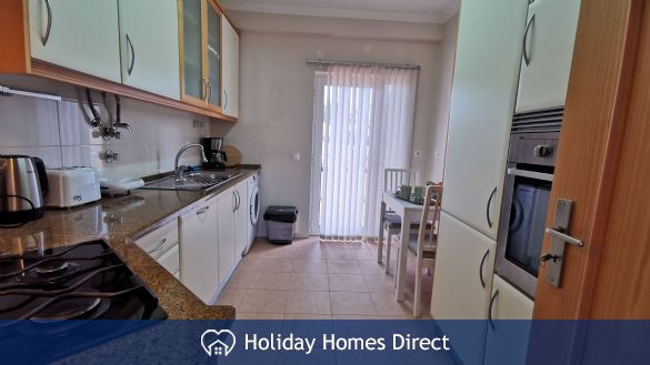 Kitchen with breakfast table and doors to veranda 